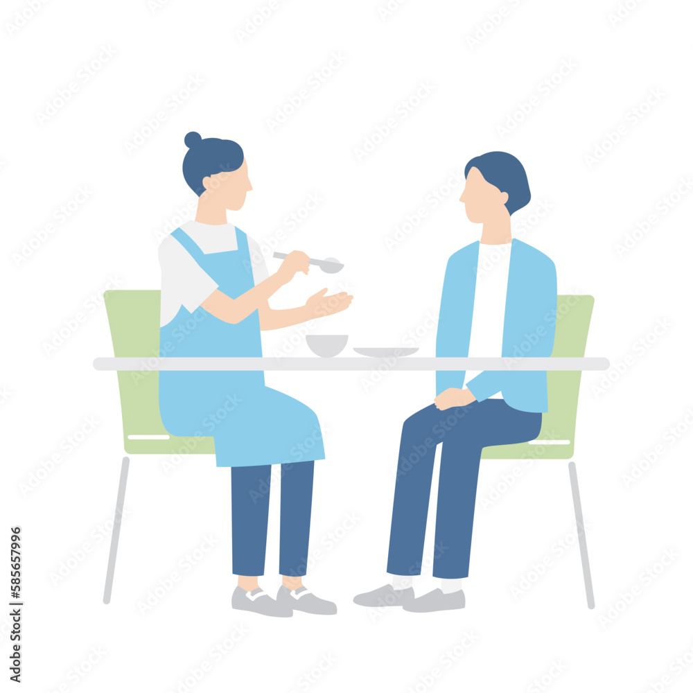 食事をする女性と介助する介護福祉士