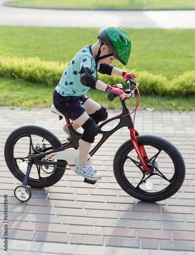 Fototapeta premium Boy in helmet with bicycle outdoor