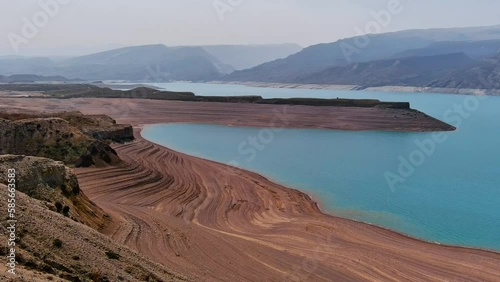 Aerial landscape with giant calm lake and mountains in Dagestan. Drone shot of a big reservoir surrounded by mountains. photo