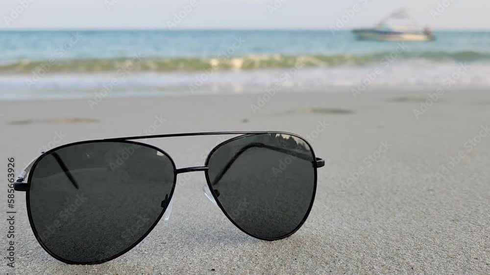 Sunglasses on beach in front of ocean, Samui, Thailand