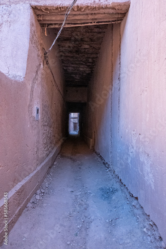 An alley of a semi deserted barbarian village in the atlas mountains surrounded by date palms along the road from marrakesh to the sahara desert