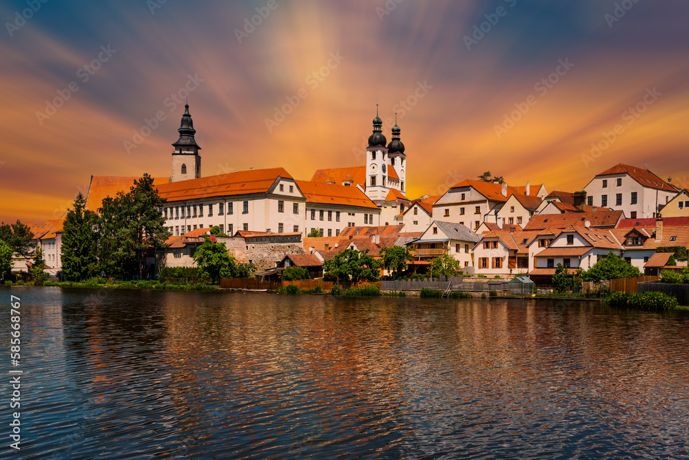 Fototapeta premium View of Telc across pond with reflections, South Moravia, Czech Republic.