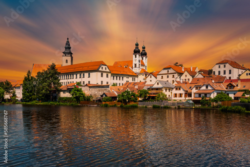 View of Telc across pond with reflections, South Moravia, Czech Republic.