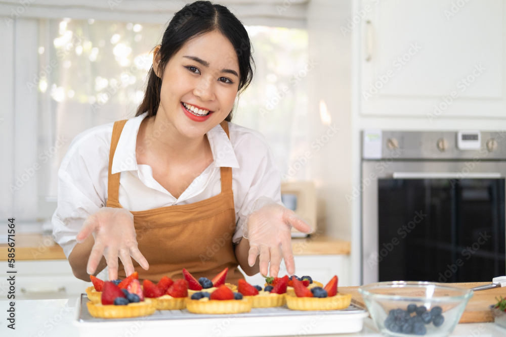 Freshly baked tart with blueberries strawberry fresh fruit kitchen for dessert.Young beautiful woman is baking in kitchen , bakery and coffee shop business.  bakery and coffee shop business.