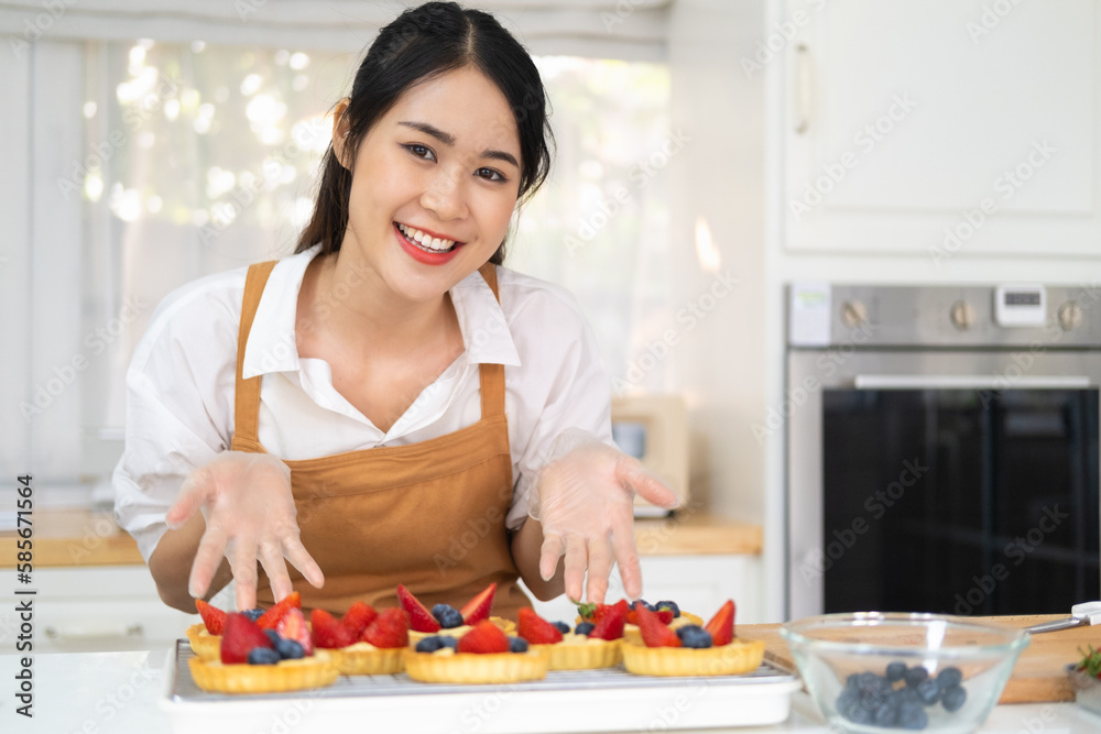 Freshly baked tart with blueberries strawberry fresh fruit kitchen for dessert.Young beautiful woman is baking in kitchen , bakery and coffee shop business. bakery and coffee shop business. Freshly baked tart with blueberries strawberry fresh fruit kitchen for dessert.Young beautiful woman is baking in kitchen , bakery and coffee shop business. bakery and coffee shop business.