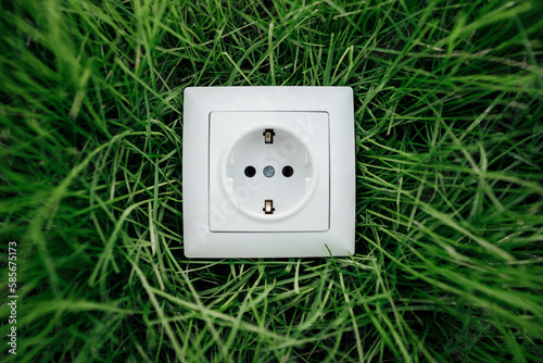 White electric socket on grass