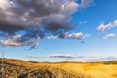 Italy, Tuscany, San Quirico d'Orcia, Clouds over rolling landscape of Val d'Orcia