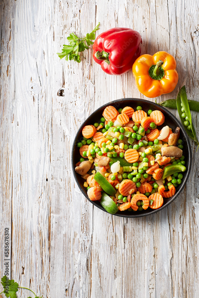 Raw bell peppers and chopped vegetables in bowl Raw bell peppers and chopped vegetables in bowl