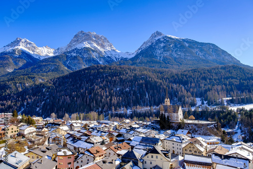 Switzerland, Graubunden Canton, Scuol, View of winter town in Engadine valley with mountains in background photo