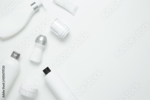 Cosmetic beauty products on white background. Bottles and tubes with branding mock up. Skin care and beauty concept. Top view, flat lay, copy space