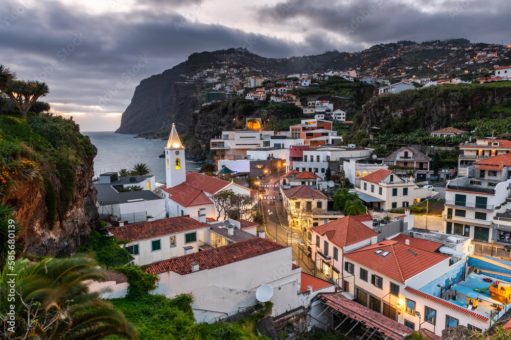 Cityscape of Camara de Lobos at dusk illuminated architecture of the seaside town in Madeira island, Portugal