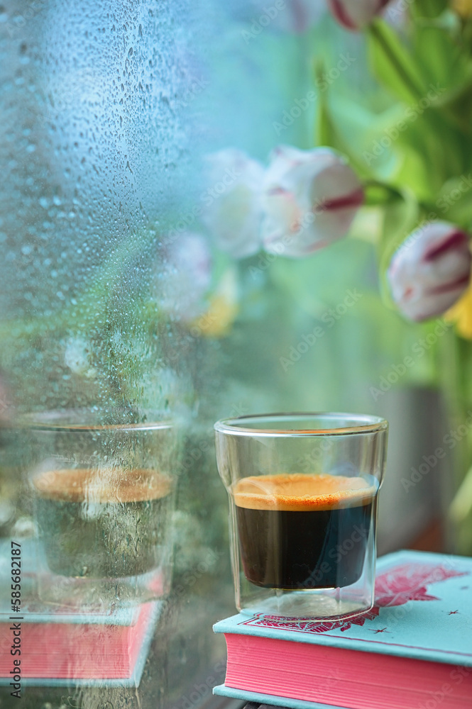 Espresso Coffee over a Book in A Rainy Day