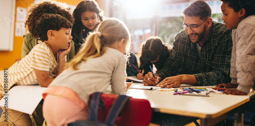 Group of elementary school kids having an art lesson with their teacher photo