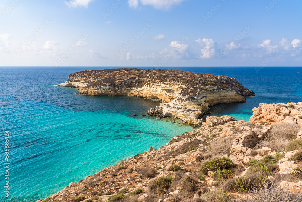 Isola dei Conigli (Rabbit Island) and its beautiful beach with turquoise sea water. Lampedusa, Sicily, Italy. Isola dei Conigli (Rabbit Island) and its beautiful beach with turquoise sea water. Lampedusa, Sicily, Italy.