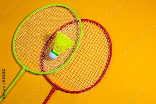 badminton rackets and shuttlecock on yellow background with copy space  © Yelena
