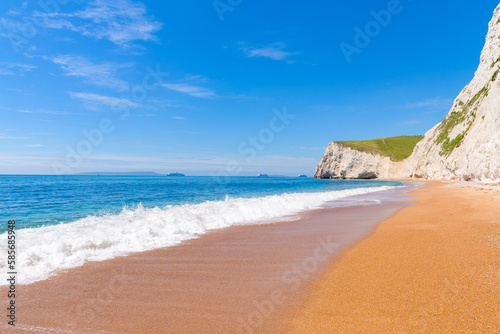 White chalk cliffs of Bat's Head and White Nothe seen from the beach near Durdle Door.