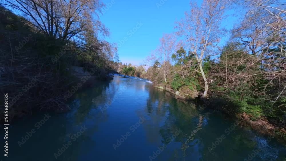 Low fpv shot overhead le Lez river with ducks swimming by a small waterfall Low fpv shot overhead le Lez river with ducks swimming by a small waterfall