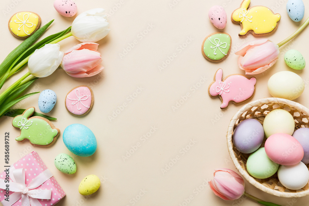 Easter frame with eggs, gift box and tulip on a colored background. The minimal concept. Top view Happy Easter composition. Card with a copy space of the place for the text