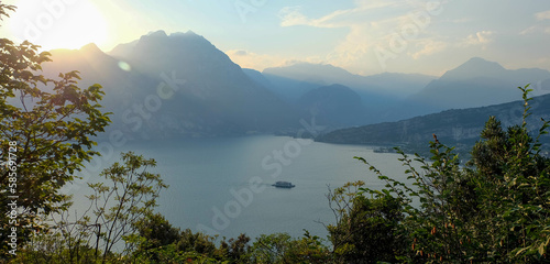 Sonnenuntergang bei Torbole am Gardasee in Italien mit Monte Brione und Fähre photo