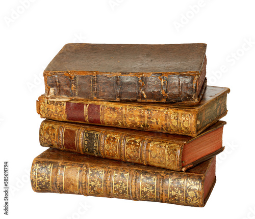 Pile of antique books with a leather cover and golden ornaments on white