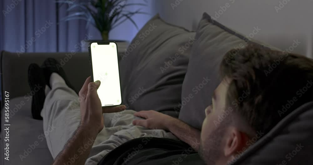 Vidéo Stock Man lying on the sofa in living room, rests on the sofa and