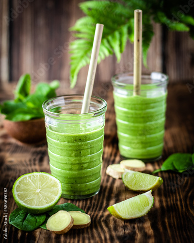 Green herb smoothie with lime ,mint ,ginger on wooden background.