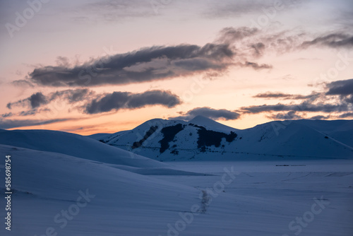 Winter landscape on dusk after sunset, beautiful mountains covered with snow