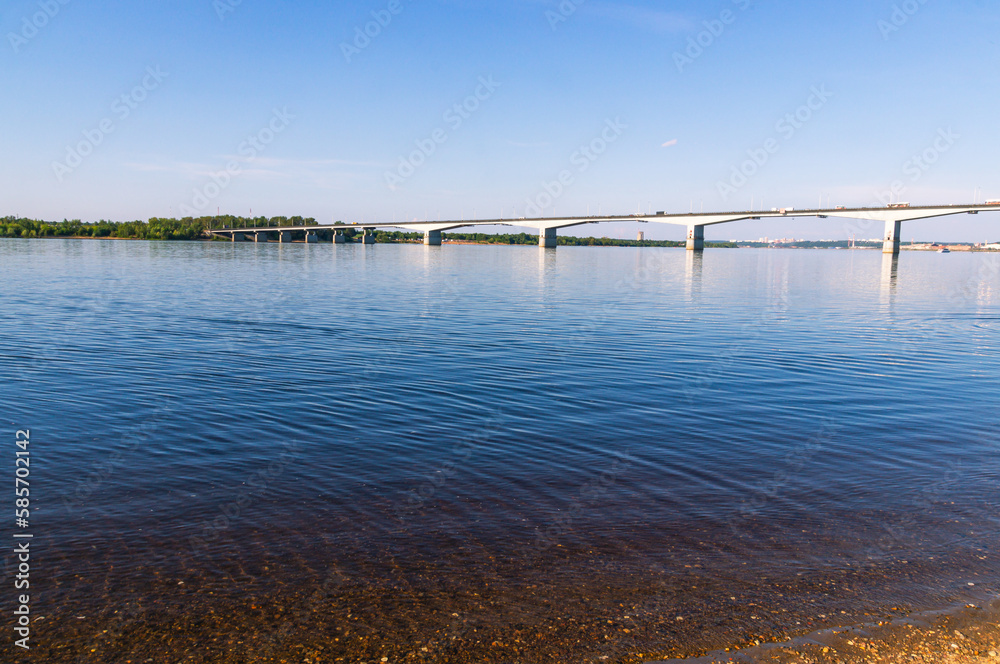 View of the river and the big bridge in summer. Landscape with a view of the big river. The water surface of the river. View of the river and the big bridge in summer. Landscape with a view of the big river. The water surface of the river.