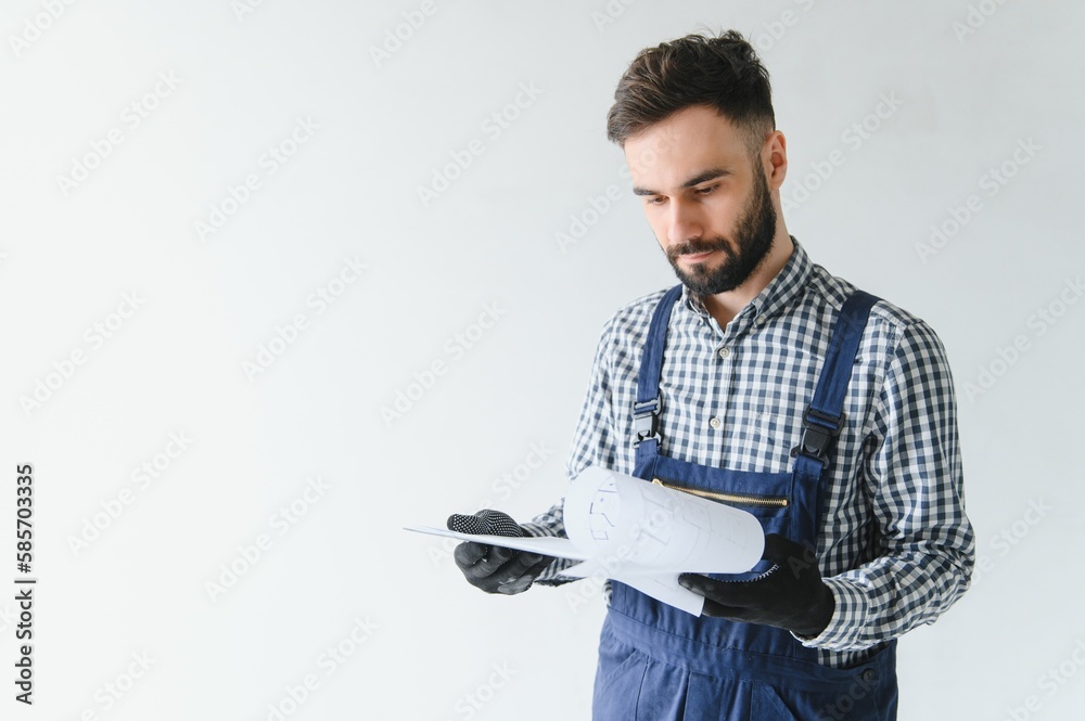 A dedicated worker doing calculations for material for apartment in construction process. A dedicated worker doing calculations for material for apartment in construction process.