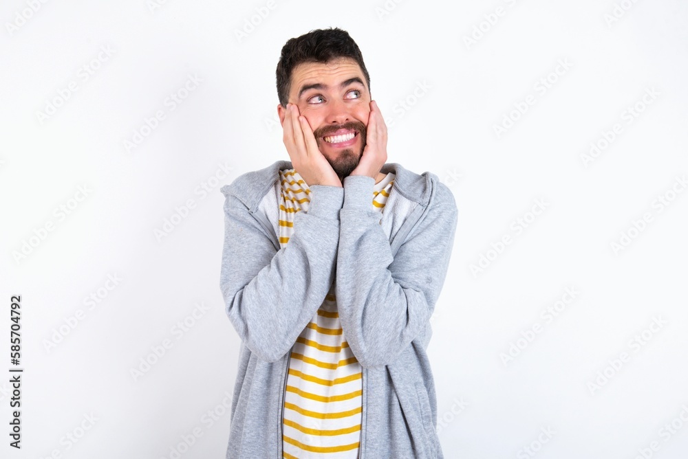 Inspired Young caucasian mán wearing trendy clothes over white background looking at copyspace having thoughts about future events