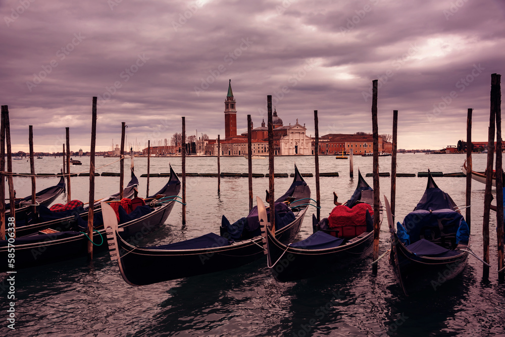 Gondolas in Venice on sunset next to San Marco square. Famous landmark in Italy