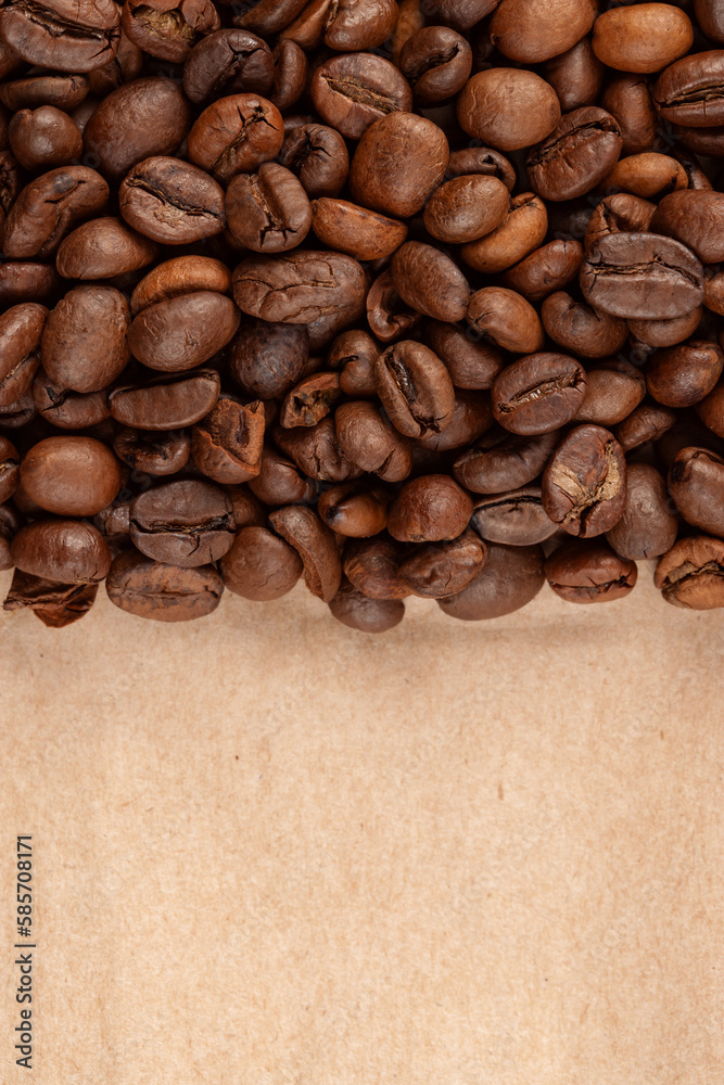 roasted whole arabica coffee beans, scattered on paper, isolated roasted whole arabica coffee beans, scattered on paper, isolated