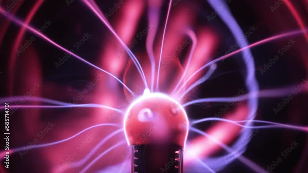 Plasma globe in slow motion. Blue and purple light beams, energy rays and pulsating light spheres slowly moving as a hand touches the surface. Close up.