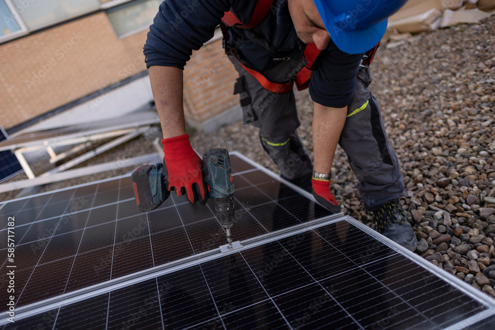 worker installing a solar panel on the roof worker installing a solar panel on the roof