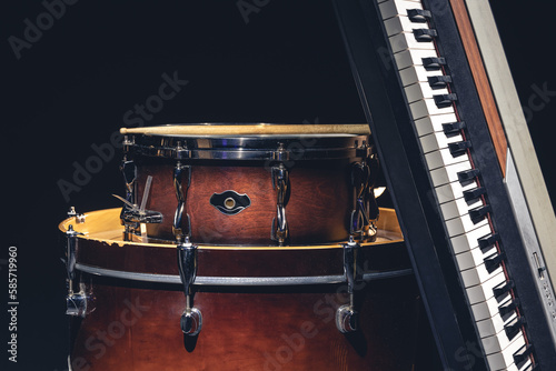 Drums and musical keys on a black background isolated.