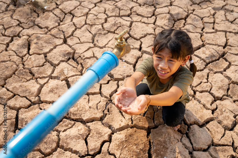 Sad kids are sitting on cracked earth open metal water old faucet on