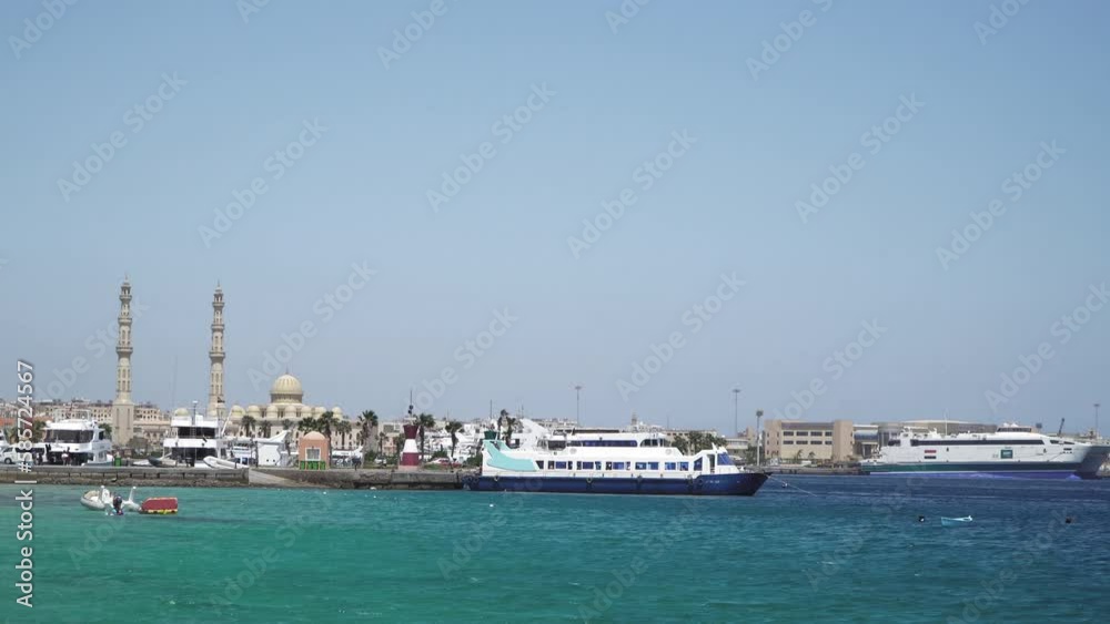 Seascape with motor yachts in marina. View of mosque in the background. Hurghada, Egypt Seascape with motor yachts in marina. View of mosque in the background. Hurghada, Egypt