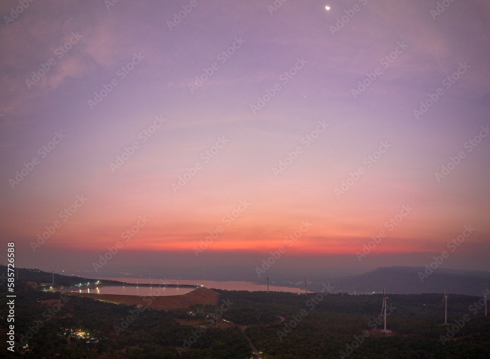Obraz premium aerial view wind turbine viewpoint at Lamtakong dam,Nakhonratchasima, Thailand. amazing sky of sunset above Lamtakong dam beautiful reflection on the large pond. Gradient color. Sky texture, 