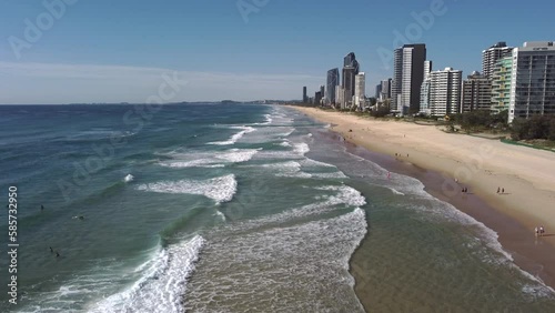 an ascending aerial clip facing south on main beach at surfers paradise on the gold coast of qld, australia