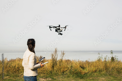 Woman flying drone using remote control