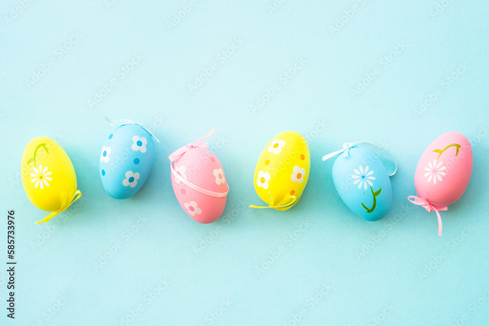 Easter eggs on blue background. Flat lay with copy space.