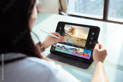 Mobile,Tablet video editor application concept.Female using digital tablet to editing video content