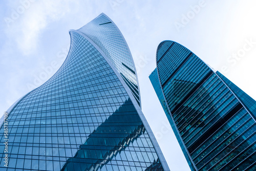 Moscow, Russia - June 2022: Skyscrapers of Moscow City. Moscow City is a business district in the center of Moscow. Tops of modern corporate high-rise buildings against the blue sky. 