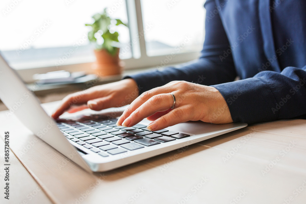 Woman using laptop on wooden table Woman using laptop on wooden table