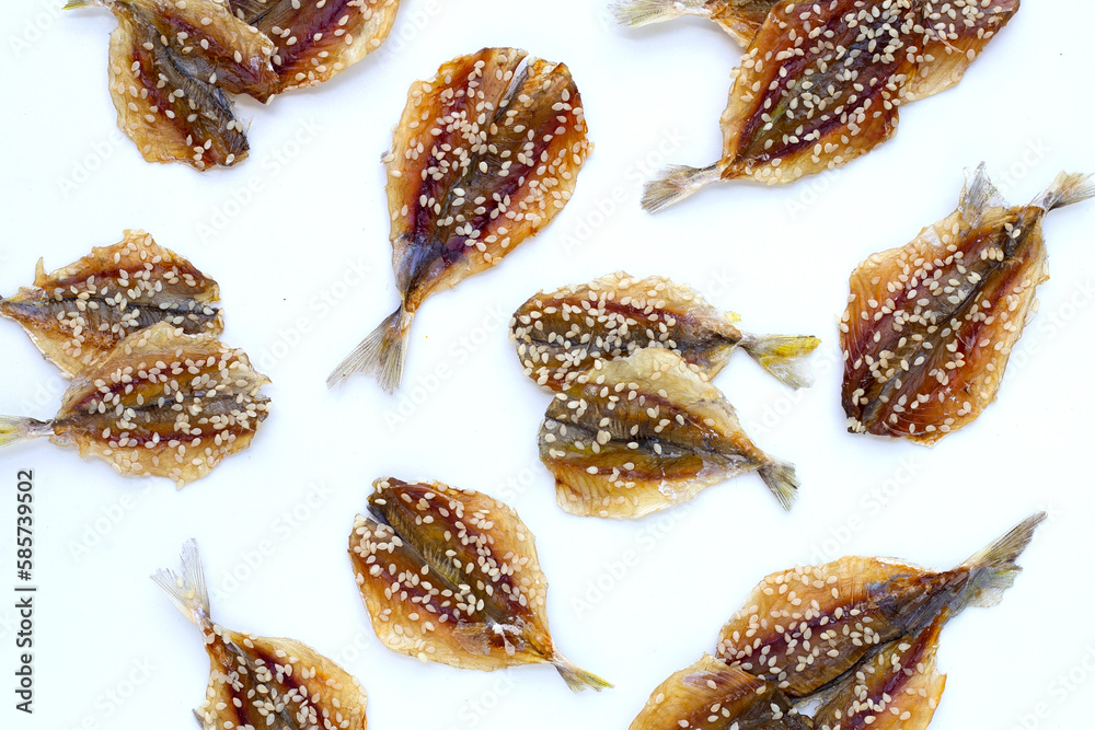 Dried fish with sesame seeds on white background. Dried fish with sesame seeds on white background.