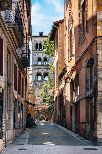 View on the Rue de la Table Ronde  a cute street in Vienne s old town  with the bell tower of Saint Andre le Bas church in the background  Isere  France 