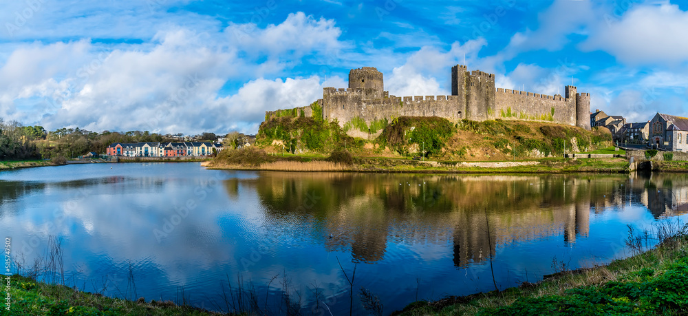 A panorama view across the River Cleddau and the Norman castle at Pembroke, Wales on a bright day