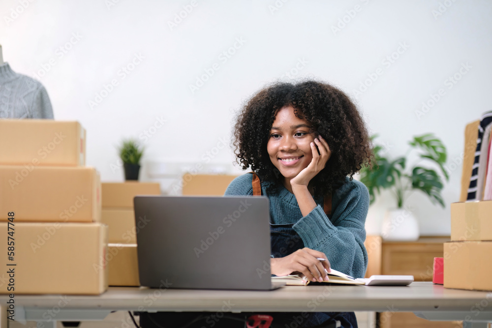 Young woman freelancer sme business online shopping look at camera with cardboard box on table at home - Business online shipping and delivery concept Young woman freelancer sme business online shopping look at camera with cardboard box on table at home - Business online shipping and delivery concept