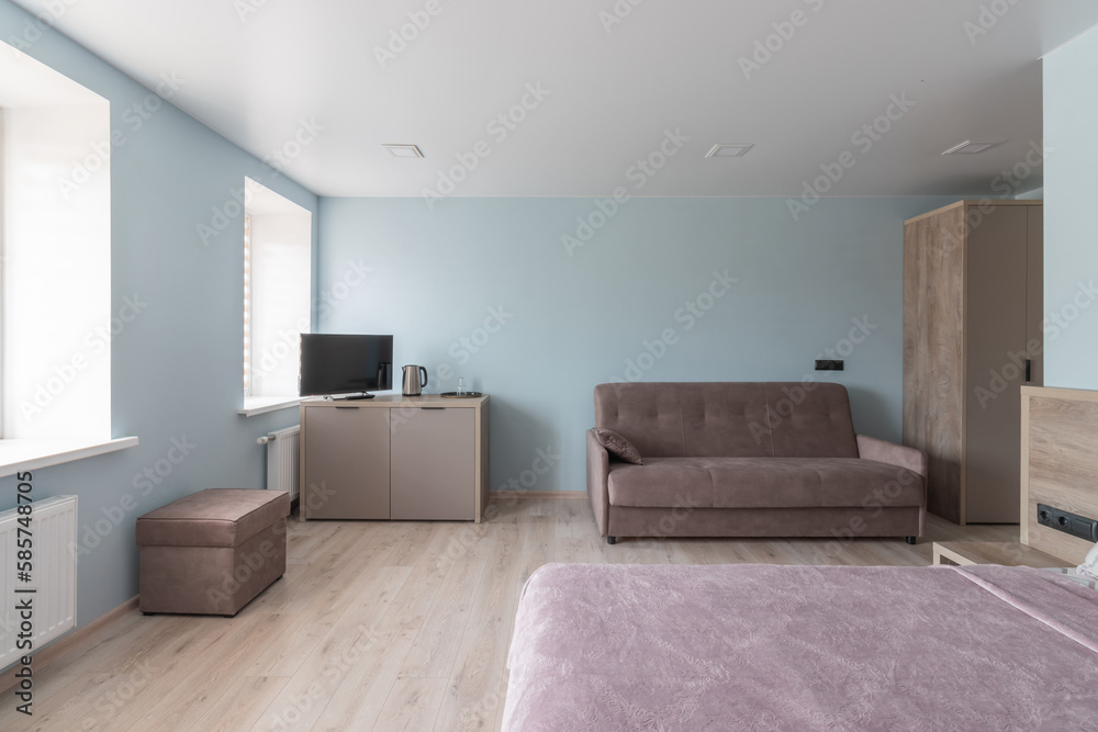 Fototapeta premium Hotel room with a large double bed in light colors