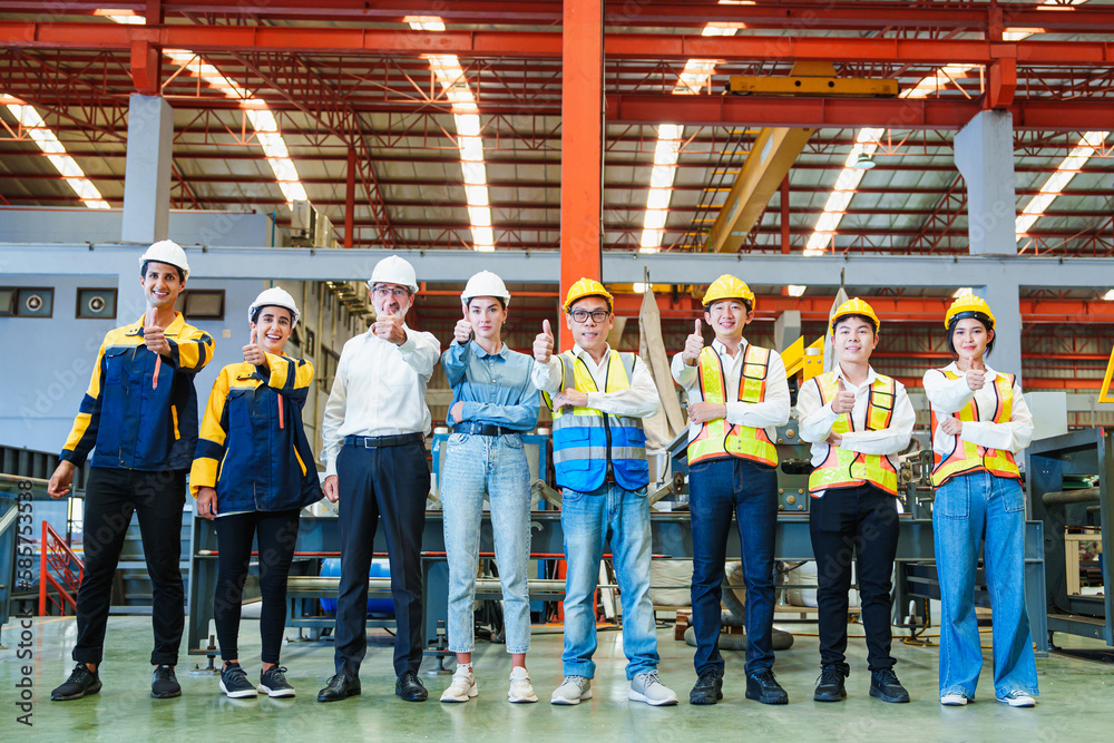 Portrait of smiling group of diverse corporate colleagues standing with makes thumb up gesture in row together at the modern metalwork warehouse factory. Metal Sheet Roofing forming machine. Like - obrazy, fototapety, plakaty 